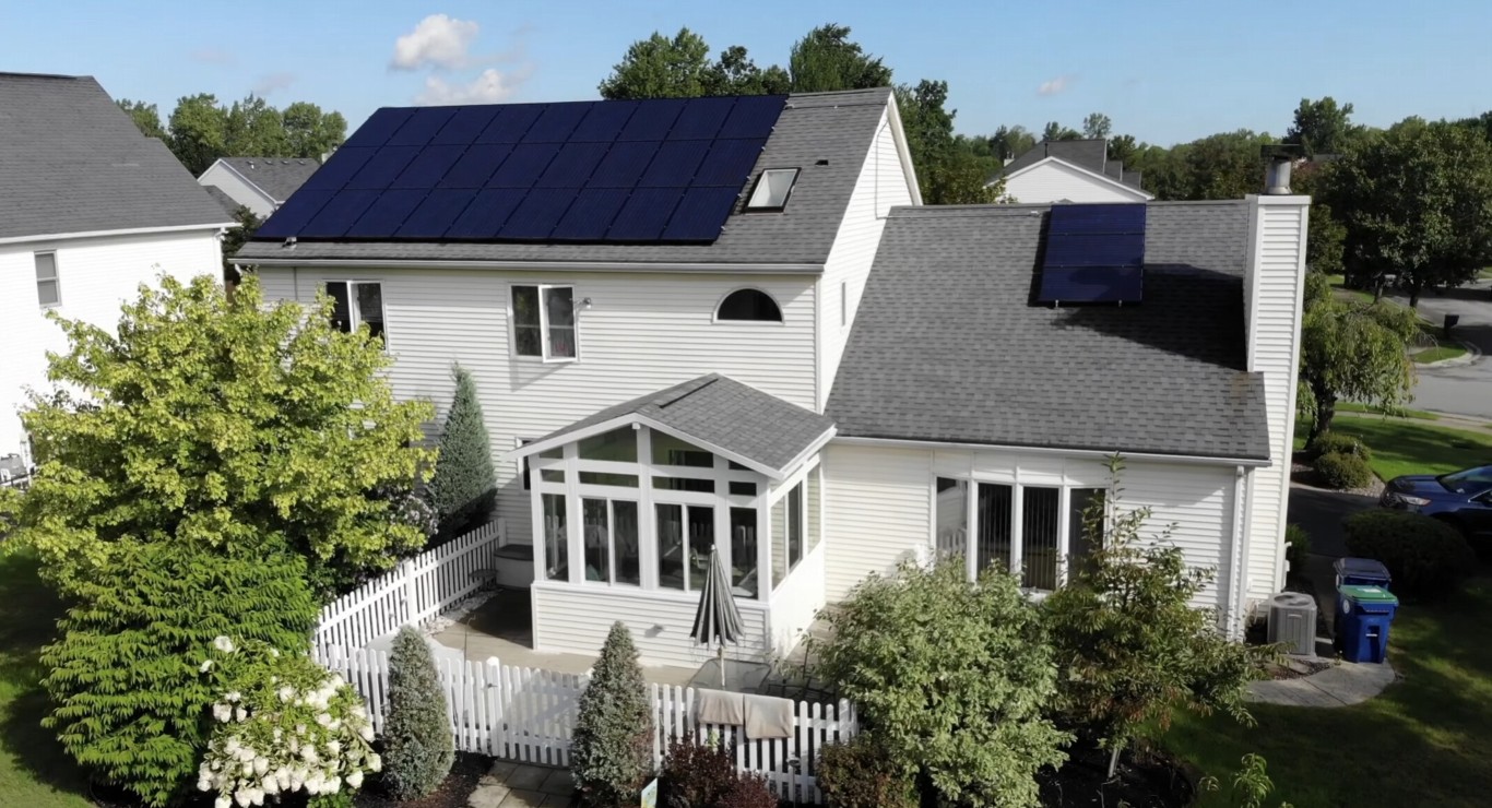 Energy-efficient white sunroom with solar panels installed in San Mateo